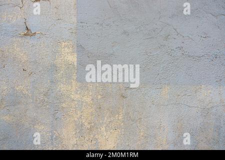 Grey concrete wall background texture. Old grunge uneven surface with scratches and cracks. Rough plaster cement gypsum wall outdoors Stock Photo