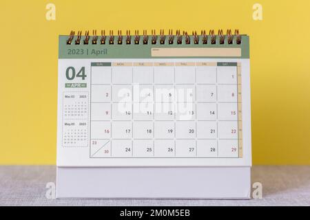 Hello April.Desktop calendar for April 2023 on the table Stock Photo