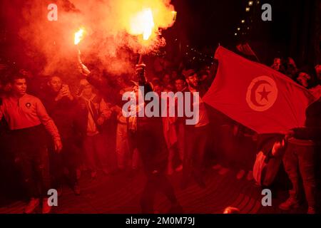 Barcelona, Spain. 06th Dec, 2022. Supporters of the Moroccan soccer team celebrate their victory over Spain in the Qatar 2022 World Cup with lit red flares on La Rambla in Barcelona. The Moroccan community residing in Barcelona went out to celebrate their pass to the quarterfinals on the Ramblas of Barcelona after beating the Spanish team in the Qatar 2022 World Cup. Credit: SOPA Images Limited/Alamy Live News Stock Photo