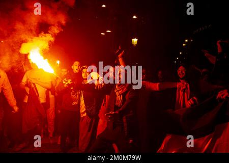 Barcelona, Spain. 06th Dec, 2022. Supporters of the Moroccan soccer team celebrate their victory over Spain in the Qatar 2022 World Cup with lit red flares on La Rambla in Barcelona. The Moroccan community residing in Barcelona went out to celebrate their pass to the quarterfinals on the Ramblas of Barcelona after beating the Spanish team in the Qatar 2022 World Cup. Credit: SOPA Images Limited/Alamy Live News Stock Photo