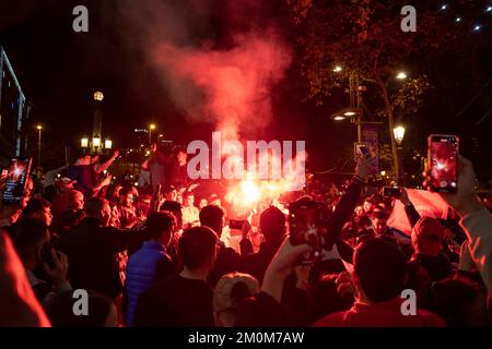 Barcelona, Spain. 06th Dec, 2022. Supporters of the Moroccan soccer team celebrate their victory over Spain in the Qatar 2022 World Cup with lit red flares on La Rambla in Barcelona. The Moroccan community residing in Barcelona went out to celebrate their pass to the quarterfinals on the Ramblas of Barcelona after beating the Spanish team in the Qatar 2022 World Cup. Credit: SOPA Images Limited/Alamy Live News Stock Photo