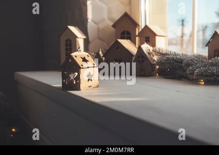wooden houses stand on the windowsill, New Year's decor Stock Photo