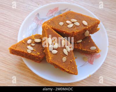 An Indian sweet called Besan barfi in local language. It is made with gram flour, condensed milk and sugar. Stock Photo