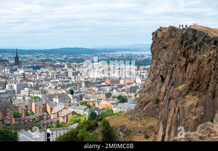 Rocky cliffs in the foreground,dominate the Scotland's capital city,with famous landmarks, Edinburgh Castle set for the Royal MilitaryTattoo,during Fr Stock Photo