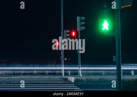 Red and Green pedestrian Crossing Signal On night long exposure Stock Photo