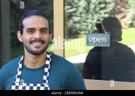 Worker with open sign in the background Stock Photo