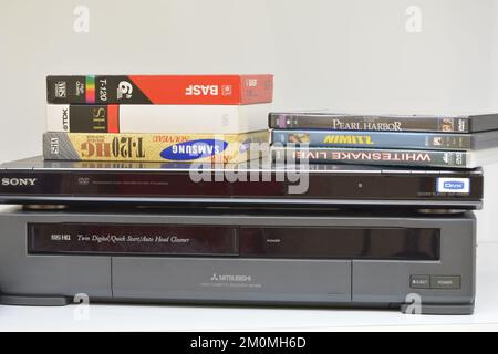 Marilia, São Paulo, Brazil - 20 October 2022: Video Cassette Recorder tapes and DVD discs on top of a DVD player and a VCR player. Brazil, South Ameri Stock Photo