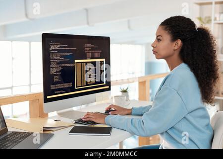 Serious female software developer working on computer in office of IT company Stock Photo