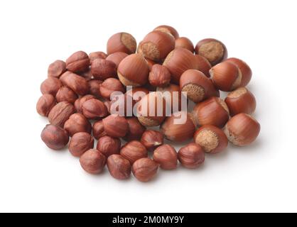 Pile of shelled and unshelled hazelnuts isolated on white Stock Photo