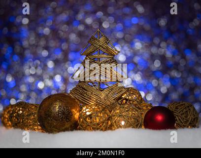 Christmas tree ornament, baubles (balls) and rattan balls lights on sparkling, shiny, colourful background. Stock Photo