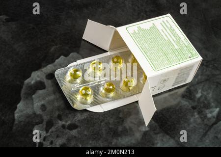 Blister of round yellow pills in a pack. Medical treatment concept. Stock Photo
