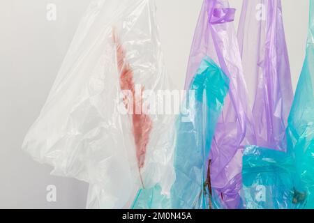 Close up hanging plastic bags with herbs. Isolated on white. Stock Photo