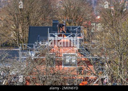 Roofers working on a residential building Stock Photo