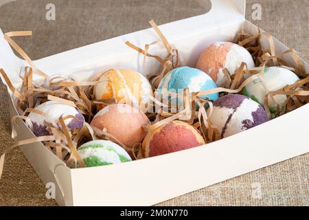 Carton box with bath bombs on table Stock Photo