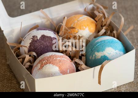 Carton box with bath bombs on table Stock Photo