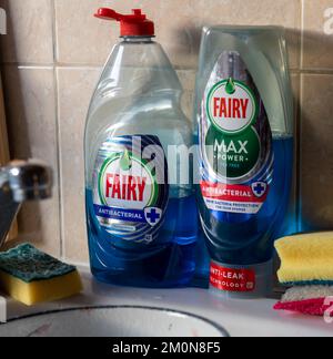 London. UK- 12.07.2022. A bottle of Fairy Max and Fairy antibacterial washing up liquid by a kitchen sink. Stock Photo