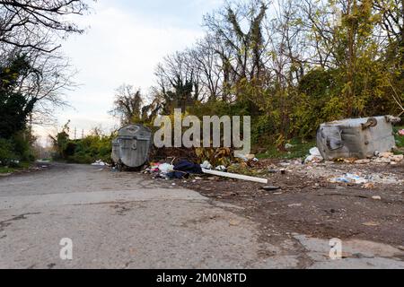 Belgrade, Serbia - November 17, 2022: Garbage pile beside dumpster scattered all over the street in Belgrade, Serbia Stock Photo