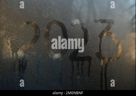 drops of water on the glass. the inscription on the wet glass 2023. the concept of Christmas Stock Photo