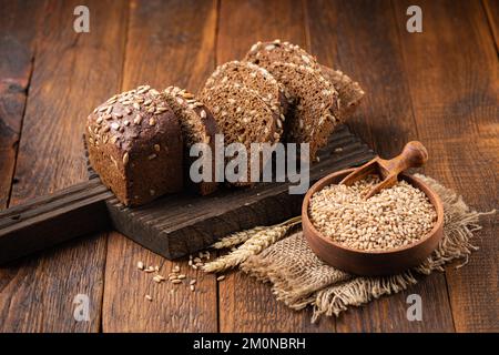Rye bread with seeds on wooden background. Healthy bread Stock Photo