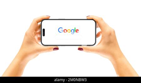Cracow, Poland - 07 December 2022: iPhone 14 Pro in a woman's hands, application Google Stock Photo