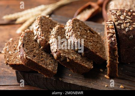 Whole grain rye bread with sunflower seeds cut into slices, closeup view Stock Photo