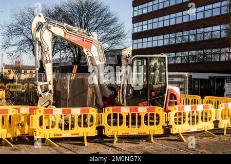 Hanley-Stoke-on-Trent, Staffordshire-United Kingdom April 21, 2022 Red and white digger on a road side construction site Stock Photo