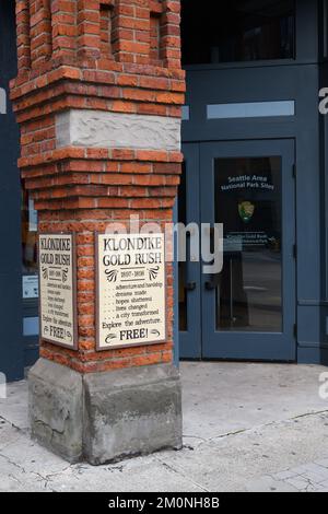 Seattle - March 20, 2022; Klondike Gold Rush National Park Site in Pioneer Square Seattle with information sign on brick post Stock Photo