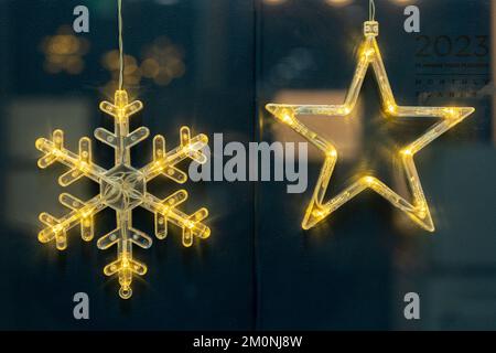 Golden snow-shaped and star-shaped Christmas decoration lights Stock Photo