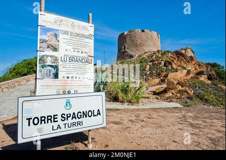 Left tourist information sign Sign for in the background historical Spanish fortified defence tower Torre Spagnola La Turri, Santa Teresa di Gallura, Stock Photo