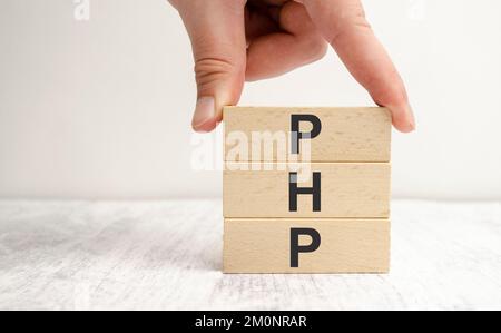 php inscription on wooden cubes on a table with white desk Stock Photo