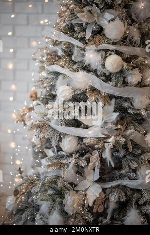 Beautiful Christmas gift boxes on floor near fir tree in room Stock Photo