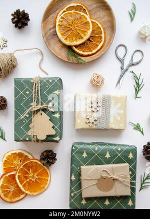 Hand crafted gifts on dark background with Christmas decorations. Seasonal background shot from above. Flat lay, top view. Stock Photo