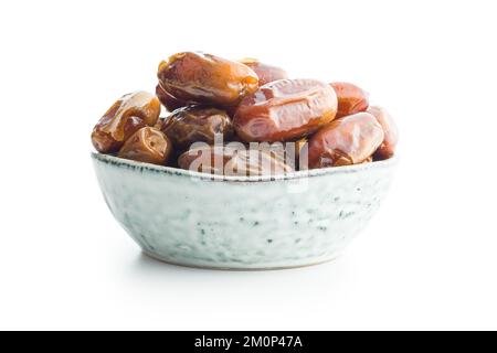 Dried dates fruit in bowl. isolated on the white background. Stock Photo