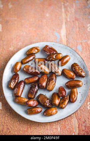Dried dates fruit on the plate. Stock Photo