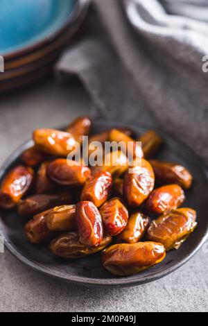 Dried dates fruit on the plate. Stock Photo