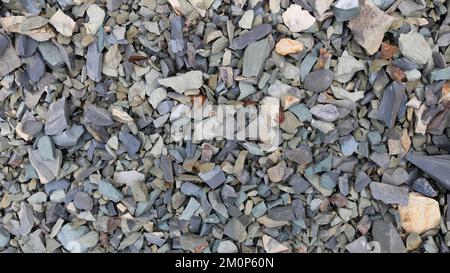 sharp crunchy stones as a textured surface, broken stones of different shades of gray and beige as a natural background full frame Stock Photo