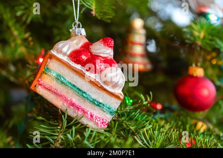 Layer cake hanging ornament in the Christmas tree. Stock Photo