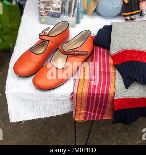 Red vintage shoes, scarf and sweater as interior decoration Stock Photo