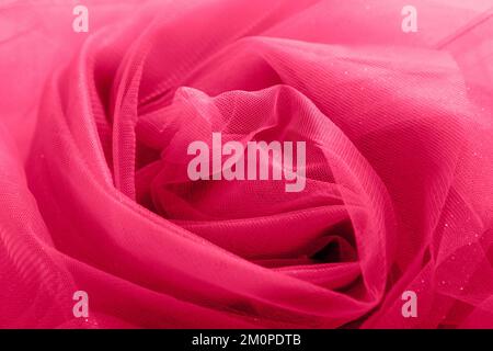 red fabric background from organza, tulle, silk. Abstract background with glitter. viva magenta Stock Photo
