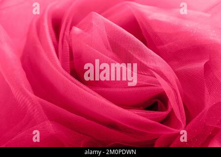 red fabric background from organza, tulle, silk. Abstract background with glitter. viva magenta Stock Photo