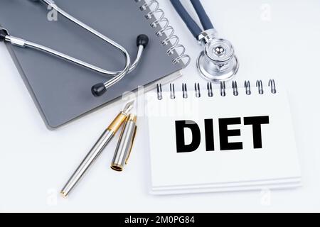 Medicine and health concept. On the table are a stethoscope, a pen and a notebook with the inscription - Diet Stock Photo