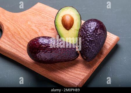 Fresh avocado on a blue background. Top view. Free space for your text. Stock Photo