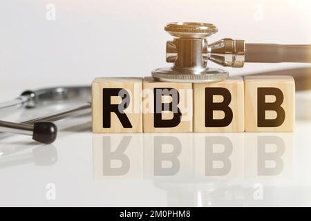 RBBB the word on wooden cubes, cubes stand on a reflective white surface, on cubes - a stethoscope. Medicine concept Stock Photo