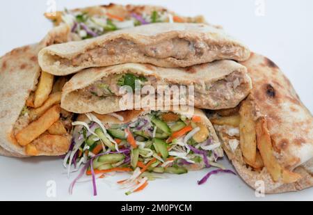 Traditional Egyptian popular breakfast street sandwiches of mashed fava beans, fried crispy falafel balls, french fries fingers and dynamite sandwich Stock Photo