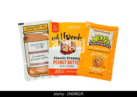 Packets of peanut, sunflower, cashew, and almond nut butters isolated on a white background. cutout image for illustration and editorial use. Stock Photo