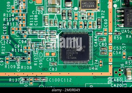 An Atheros Communications AR9285 wireless LAN controller on an integrated circuit board. The Taiwanese wireless chip maker was purchased by Qualcomm i Stock Photo