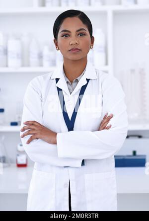 Science is serious business. Cropped portrait of an attractive young female scientist standing with her arms folded in the lab. Stock Photo