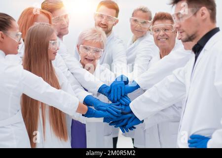 group of medical researchers making a tower out of their hands. Stock Photo