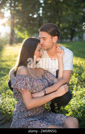 Portrait of a young loving couple sitting in a garden in summer, Bosnia and Herzegovina Stock Photo