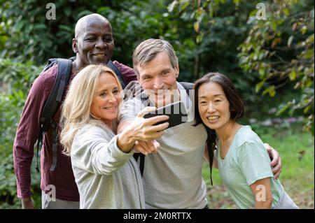 Diverse group of middle-aged friends taking a selfie while out on the backroad trails Stock Photo